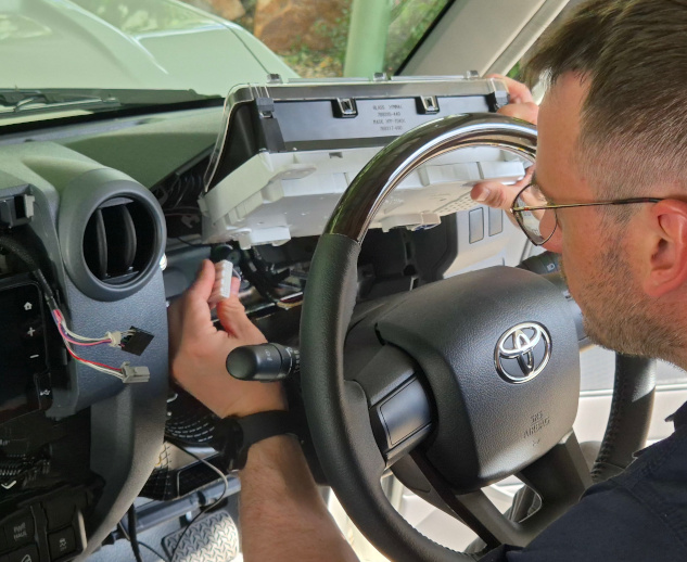 Reflow soldering of audio switching board Technician installing smart vehicle immobilization system on a car, showing reliable protection in real-life conditions